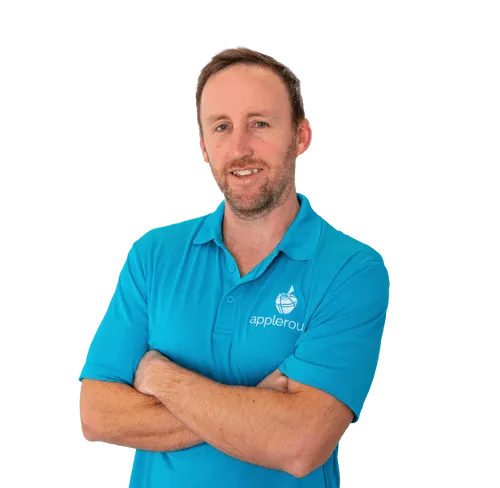 Male Program Director with his arms crossed, smiling