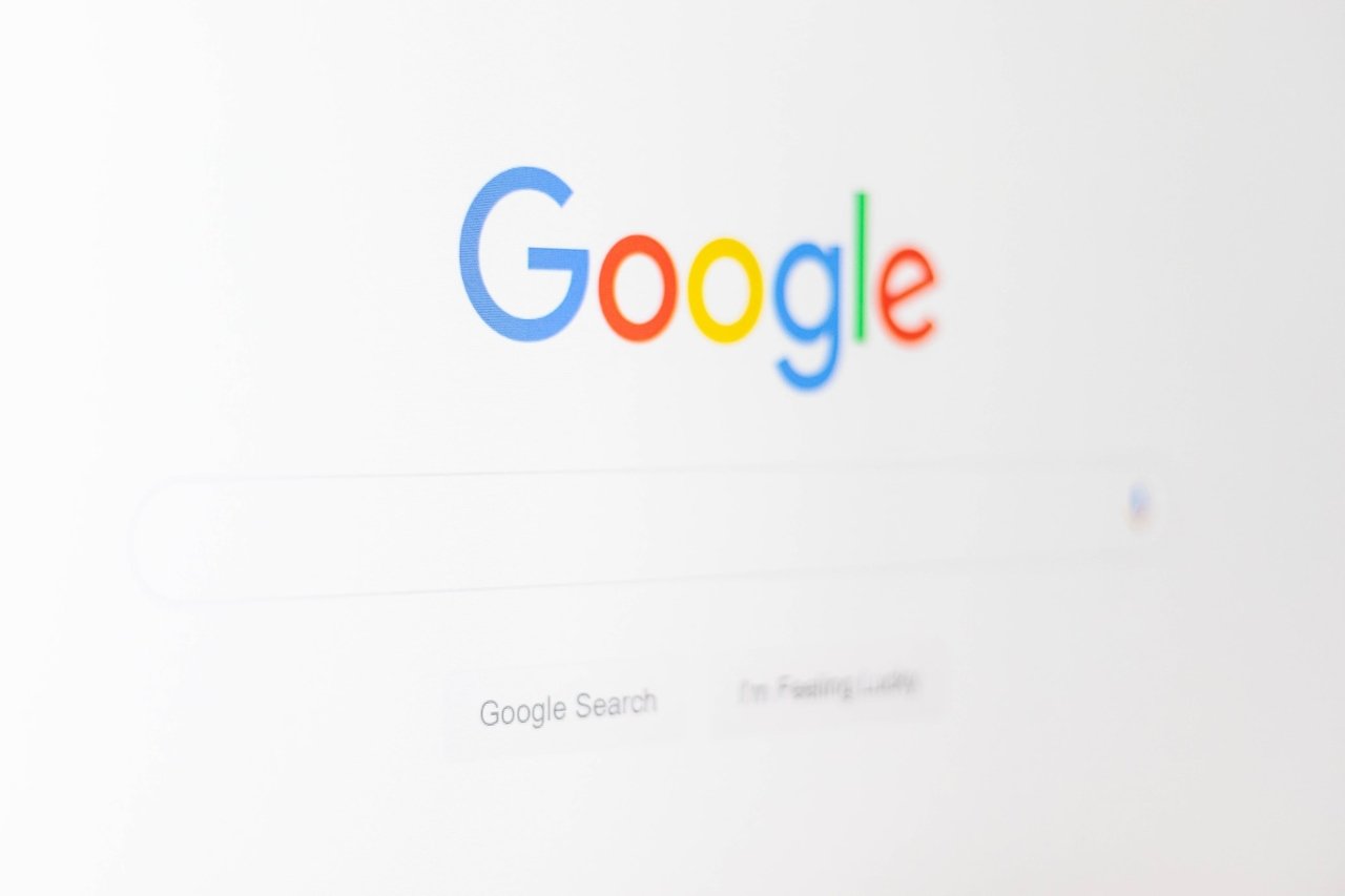 google homepage photo taken from a side angle with white background and colordul GOOGLE title above a search bar