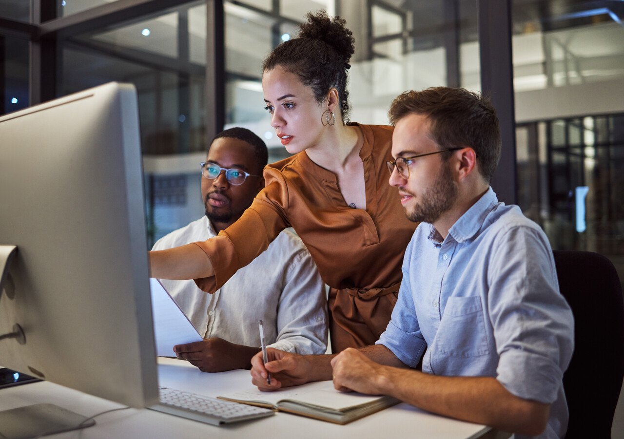 colleagues examining details on the computer