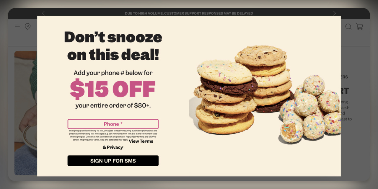 SMS signup interstitial popup offering $15 off at Milk Bar with phone field