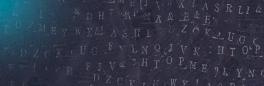 Close-up of scattered uppercase letters in various fonts on a dark surface with a bluish light flare on the left.