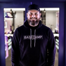 Coach Christian is a Basecamp Minnesota OG as he was one of the first hires at the very first Basecamp studio in Minneapolis back in 2019. Often told he should pursue a career as a radio DJ or as an auctioneer, Christian is known for being a hype coach and a smooth talker. In fact, he’ll talk you into back-to-back bike sprints without you even realizing it’s happening. When he’s not on the mic carrying around an energy drink that he doesn’t need, you can find Christian on the golf course, searching for a new craft beer, or running around with his twin boys and wife Emily.