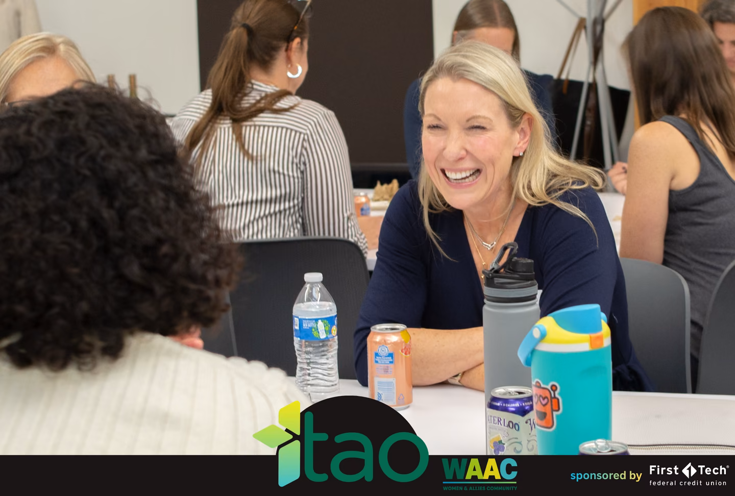 Smiling attendee chatting with others at a table during WAAC networking