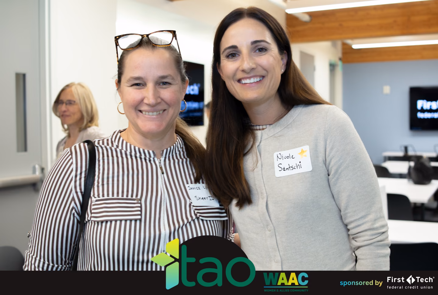 Two attendees smiling together at the TAO Women and Allies Community event