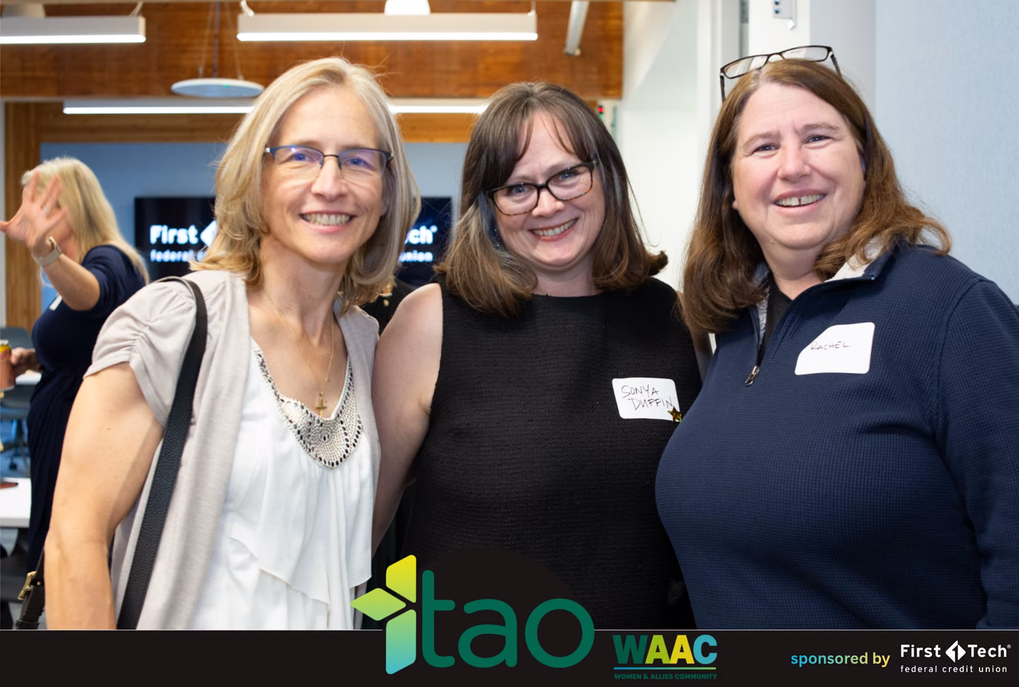 Three women in tech smiling together at the WAAC technical leadership event
