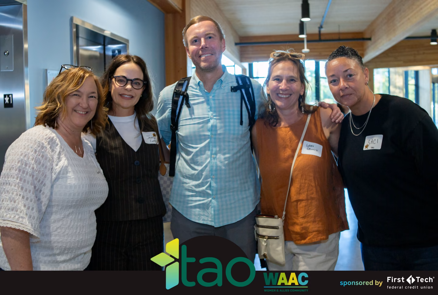 Group of attendees and allies posing together after the WAAC panel