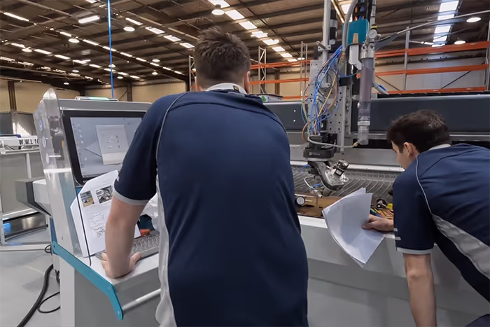 A scene depicting two CNC machinery specialists