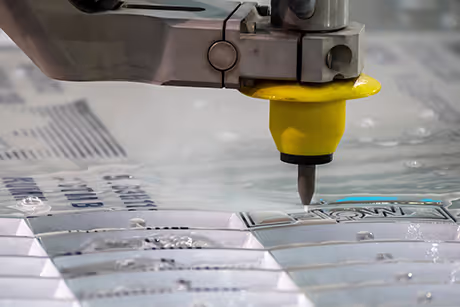 A close-up of a water jet cutting head