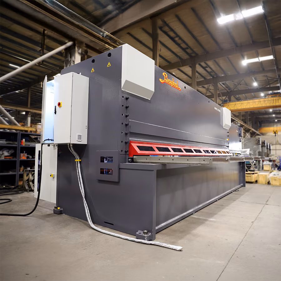 A large steel sheet guillotine on display in a workshop