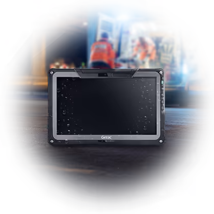 Water-resistant Getac rugged tablet on the ground with emergency responders and ambulance blurred in the background.