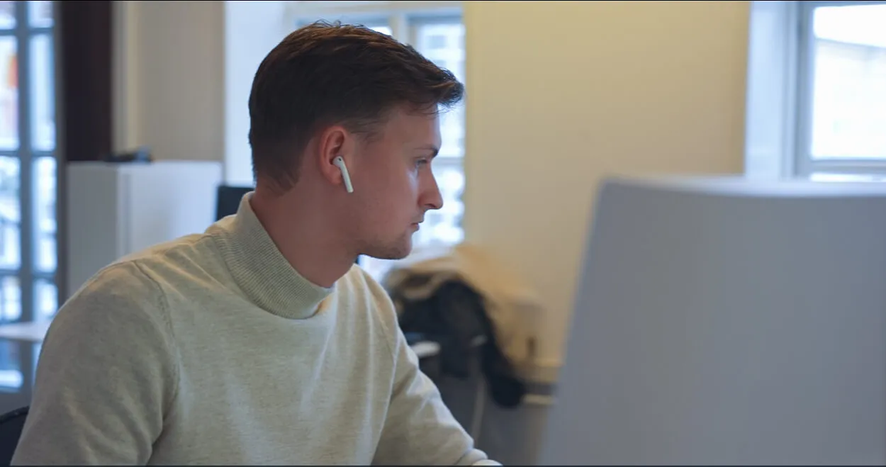 A man sitting in front of a laptop computer.