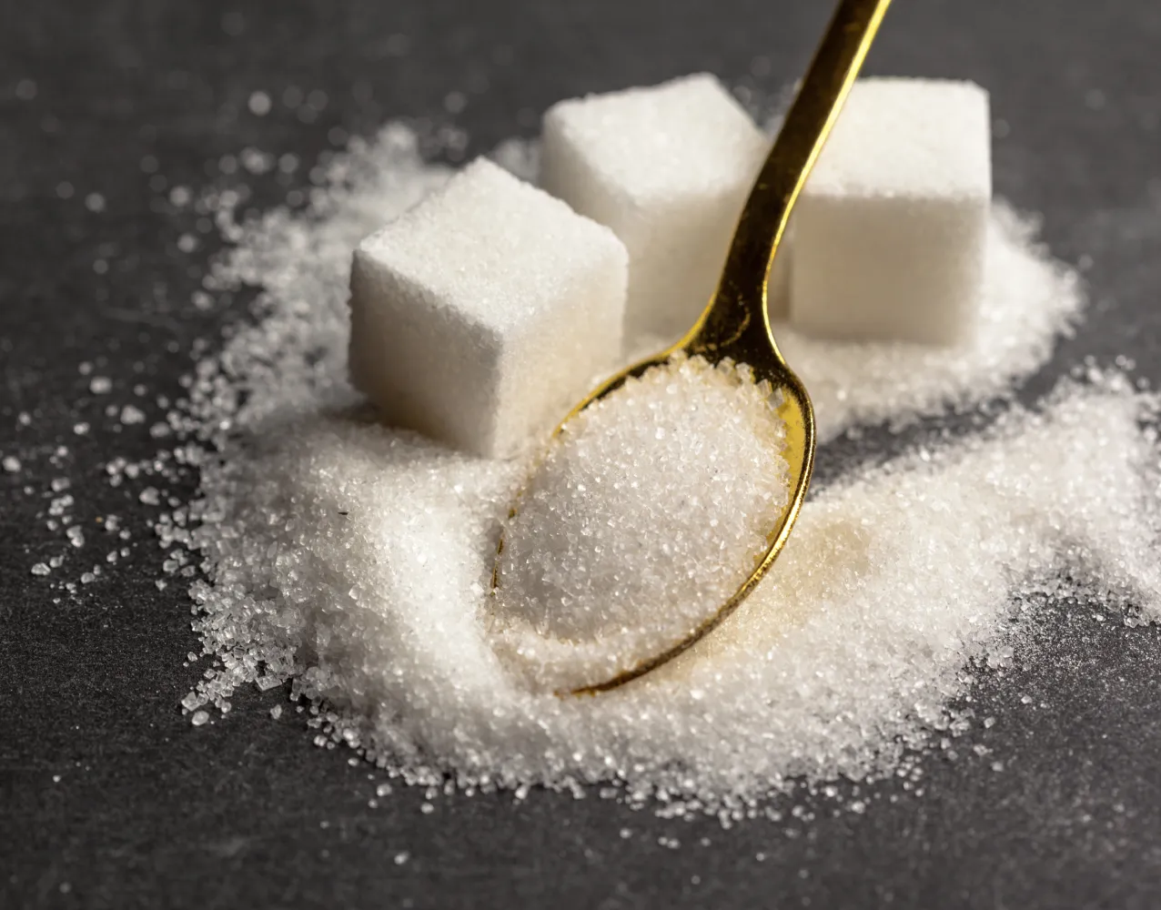 A close-up of granulated sugar, emphasizing its purity and free-flowing consistency