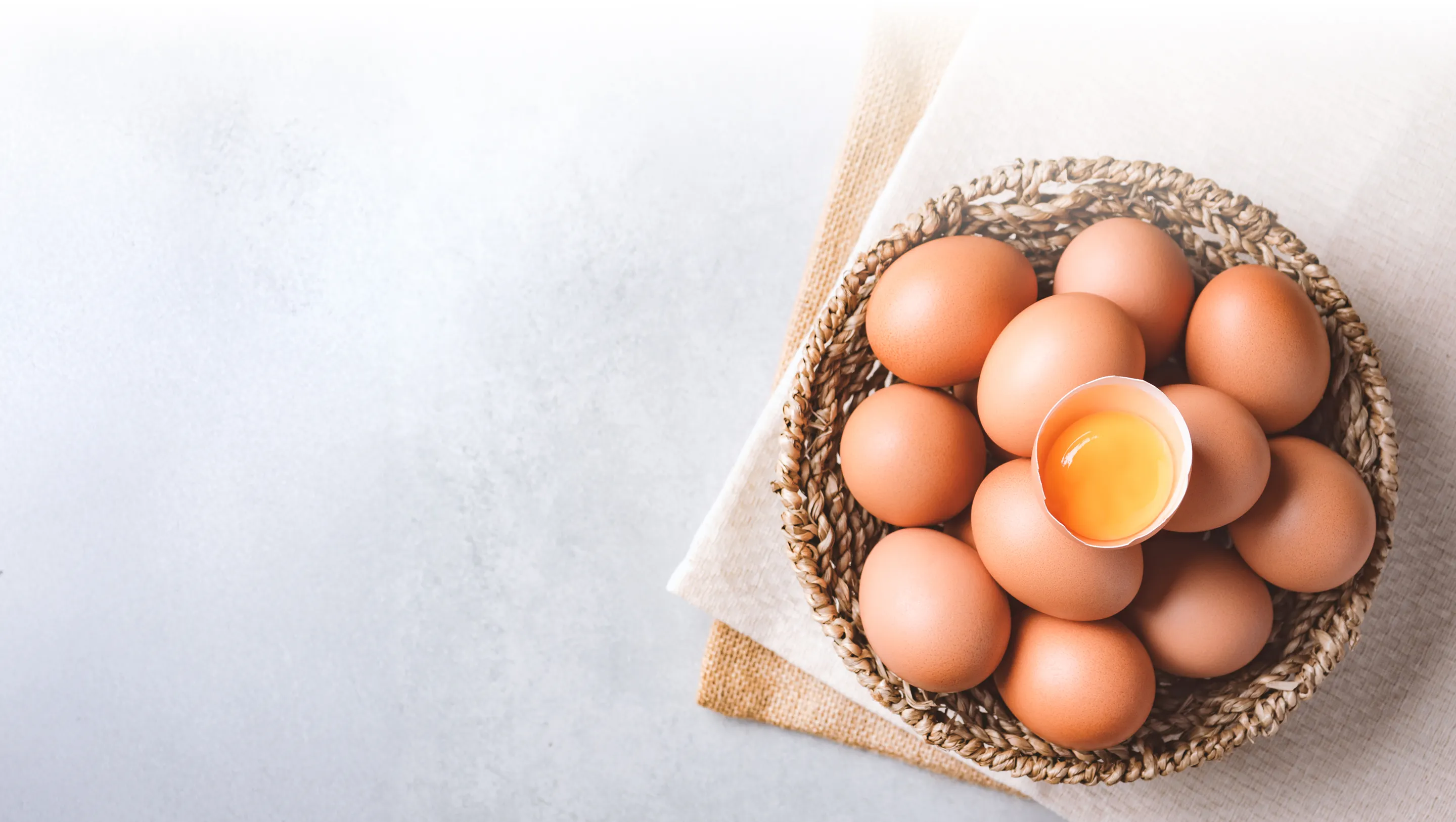 Fresh Ukrainian eggs in wicker basket with golden yolk - premium quality for UK wholesale