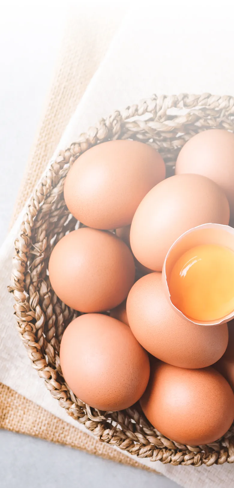 Fresh Ukrainian eggs in wicker basket with golden yolk - premium quality for UK wholesale