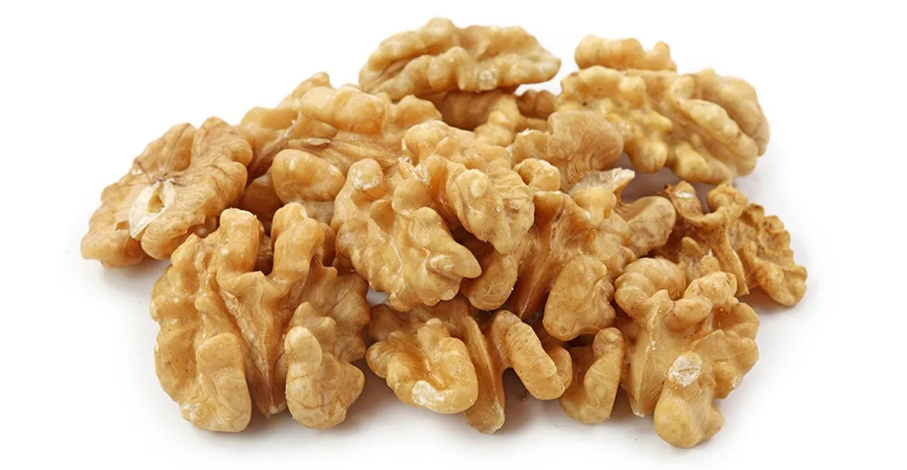 A pile of shelled Armin Plus walnut halves on a white background.