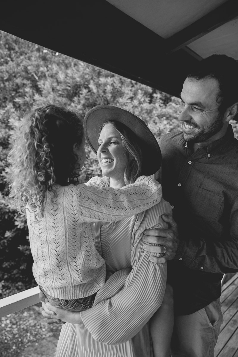 family embrace on their veranda