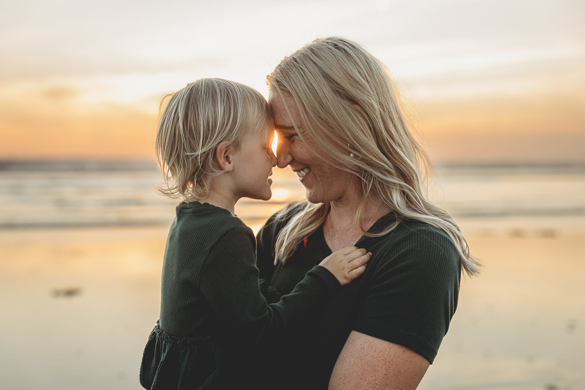mother and daughter at sunset beach