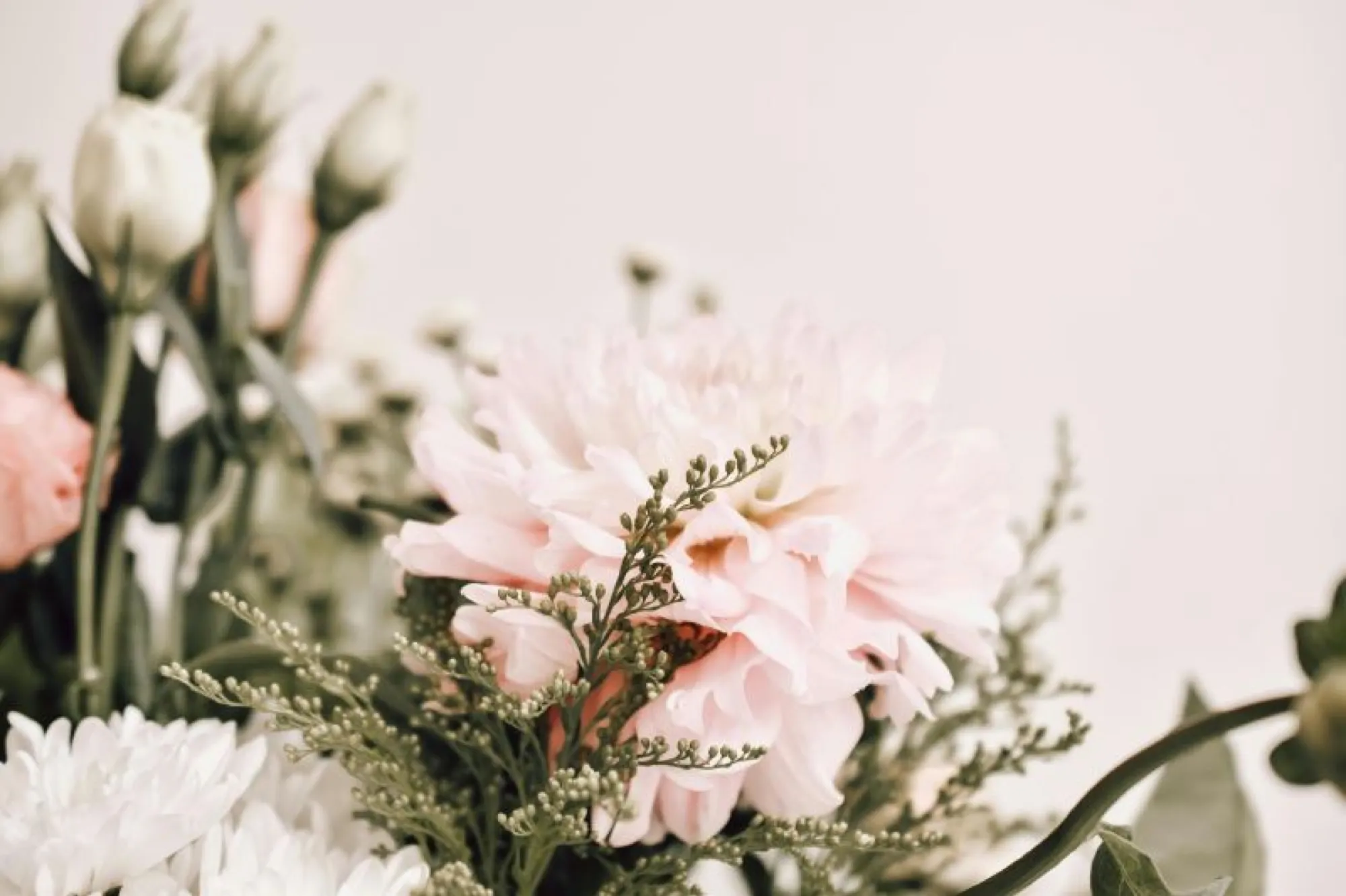 A bouquet of pink and white flowers, symbolizing love and remembrance, perfect for honoring a mother's legacy.