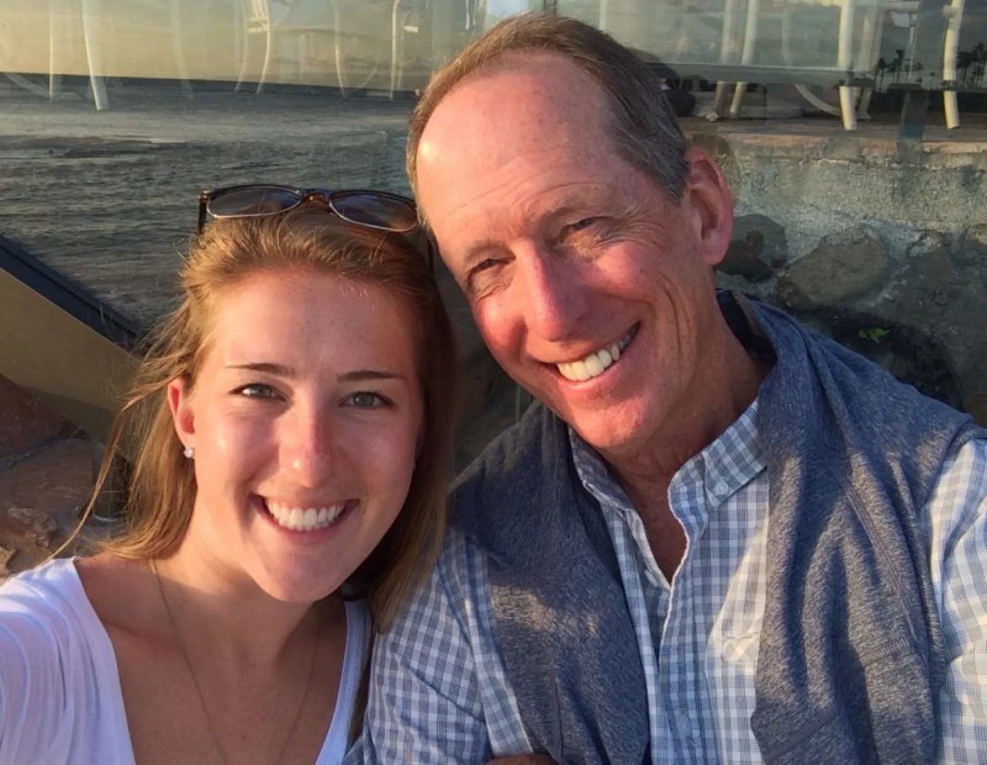 A man and woman smiling together, taking a selfie, capturing a moment of connection and support after a loss.