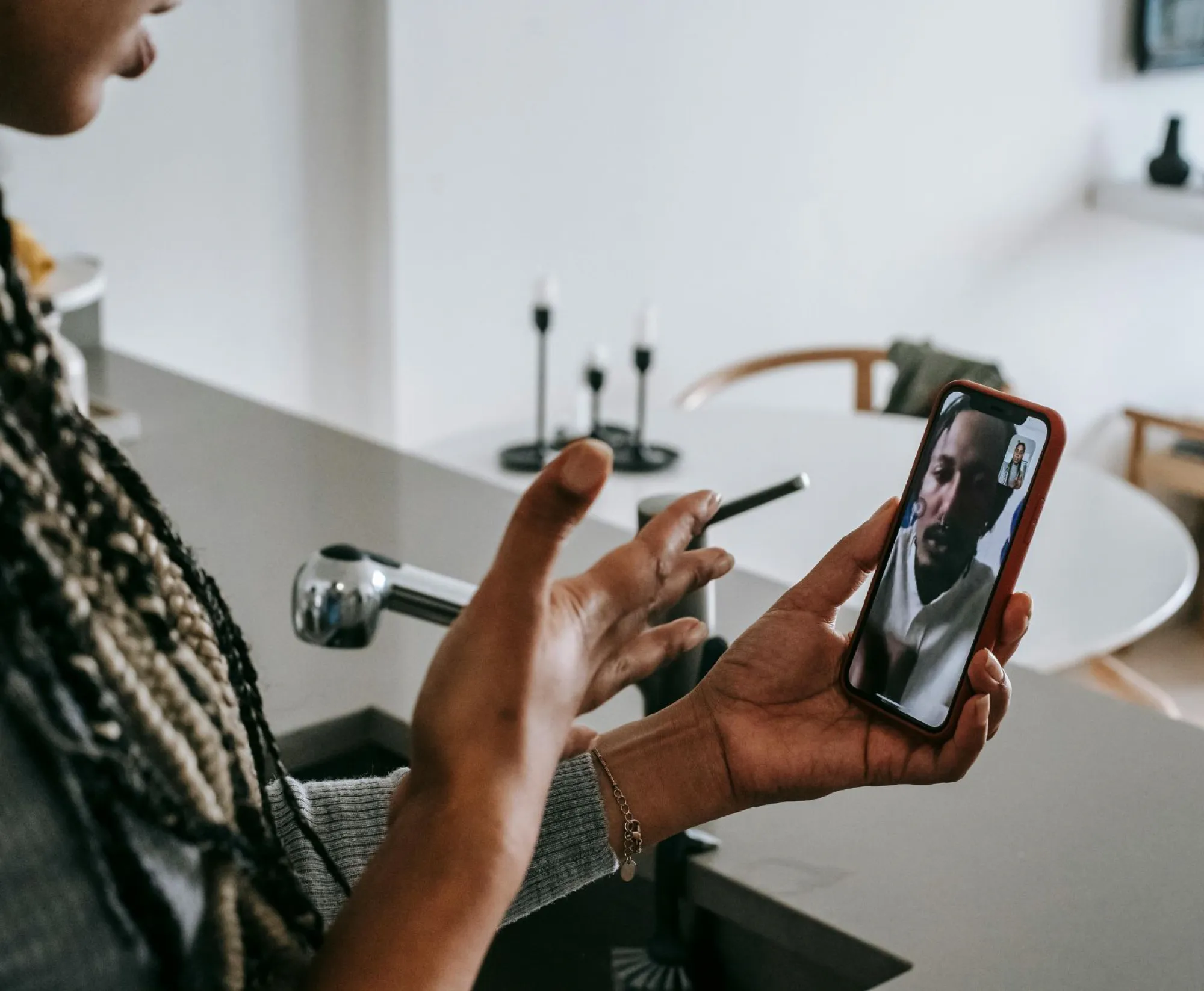 A woman video chatting on her phone, focused on the conversation while learning about will and trust responsibilities.