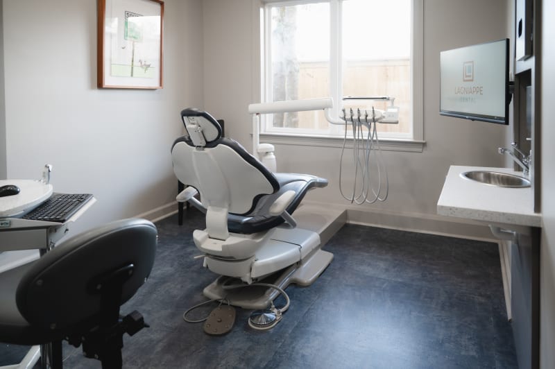 A dental chair in a treatment room at Lagniappe Dental.