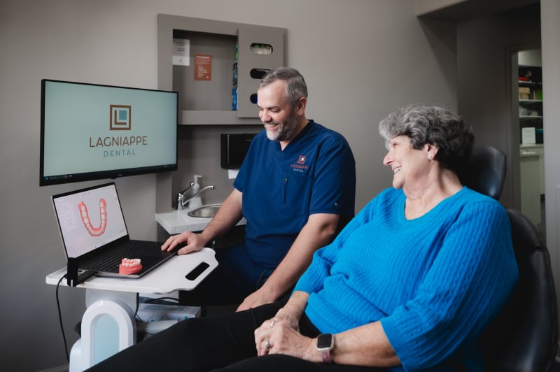 Dr. Bruce at Lagniappe Dental discussing Dental implants with a patient.