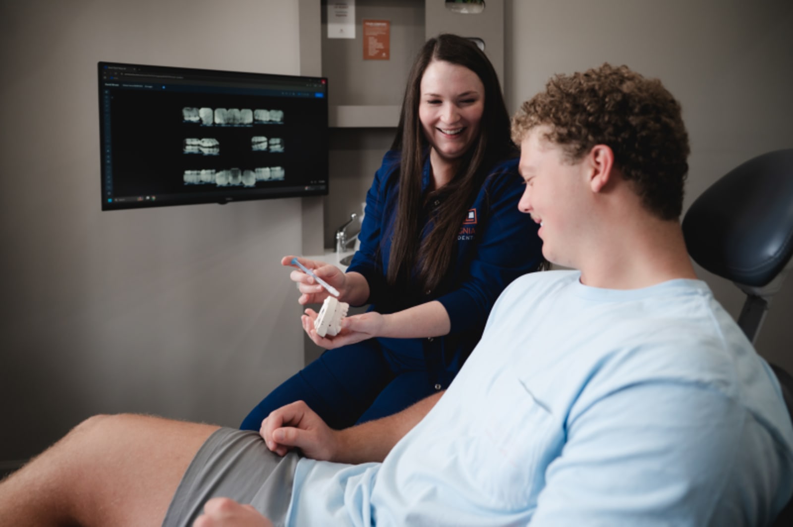 Dentist explaining digital x-rays and treatment plan to patient