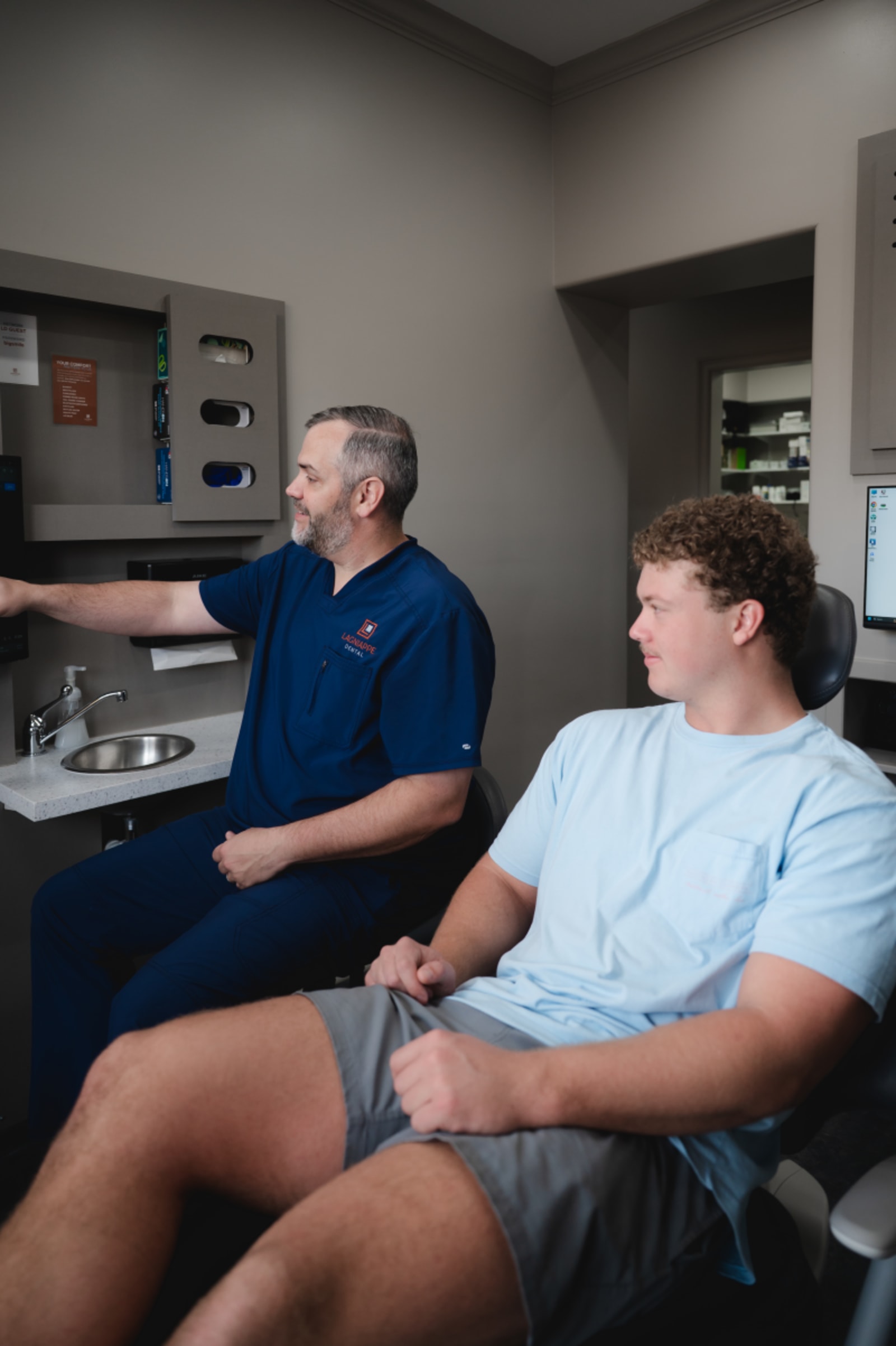 Dentist discussing implant timeline and expectations with patient