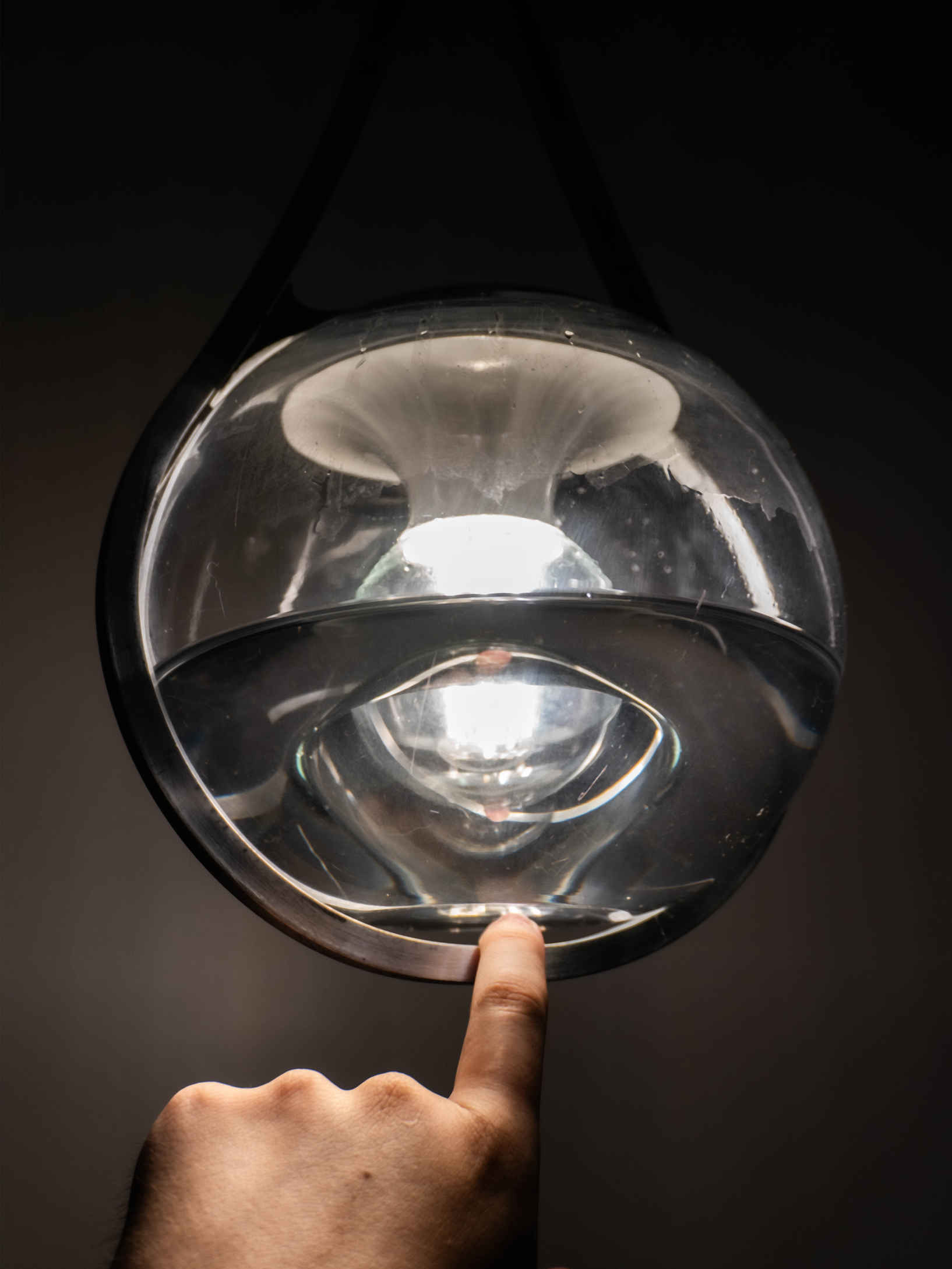 Pulling the handle under the glass orb