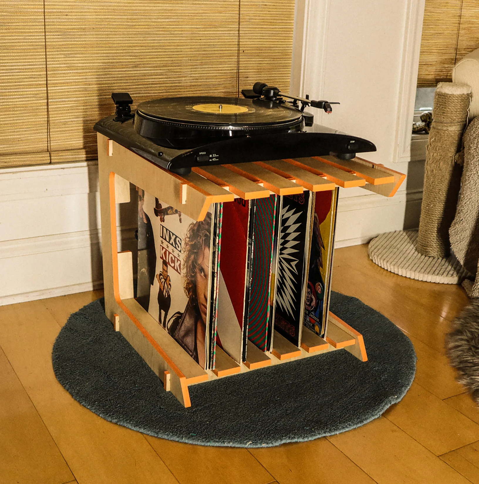 Groove table with a turntable on top and records stored below