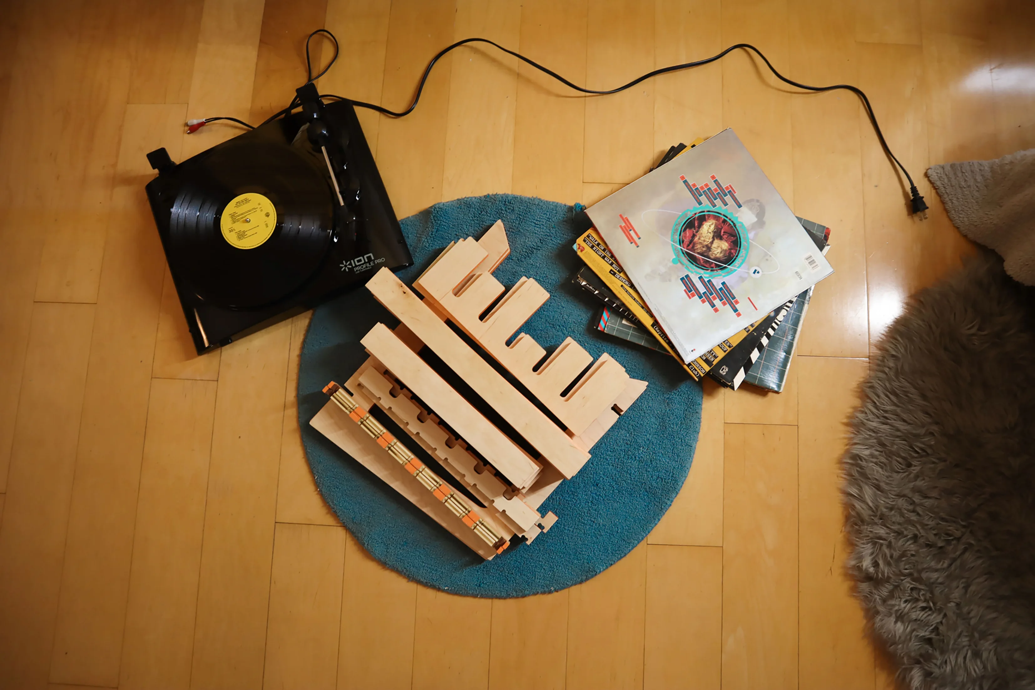Groove table flatpacked beside a turntable and records