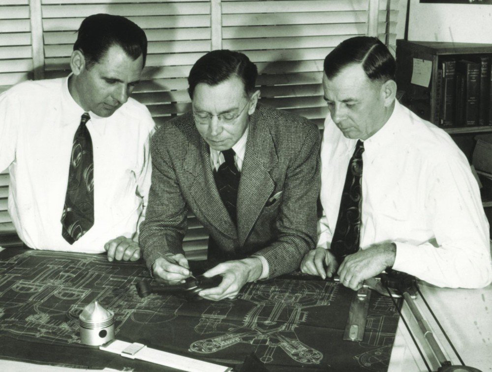 Leo Goosen and colleagues reviewing race-engine blueprints