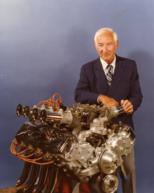 Zora Arkus-Duntov standing behind a high-performance racing engine
