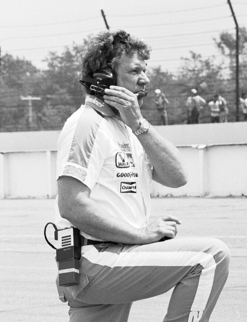 Crew chief Waddell Wilson wearing a headset beside the racetrack
