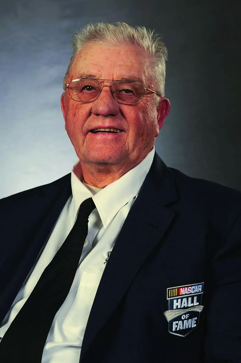 Maurice Petty wearing his NASCAR Hall of Fame blazer in a formal portrait