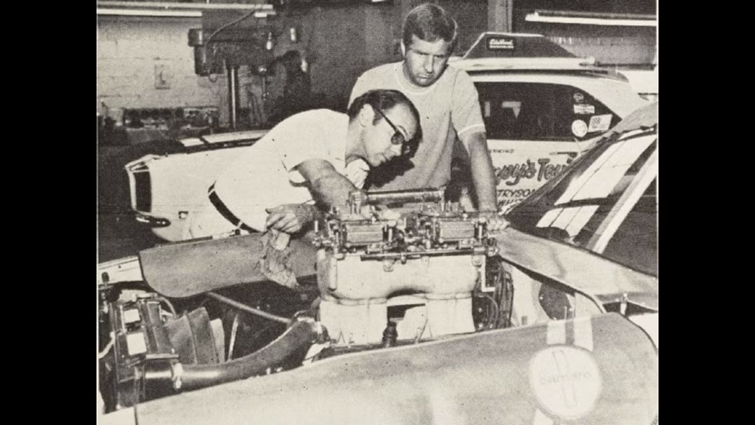 Bill Jenkins and a crew member tuning a racing engine in the workshop