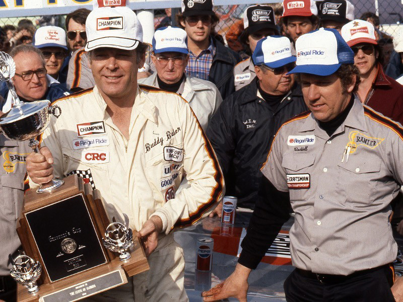 Buddy Baker carrying the Daytona 500 trophy beside crew chief Waddell Wilson