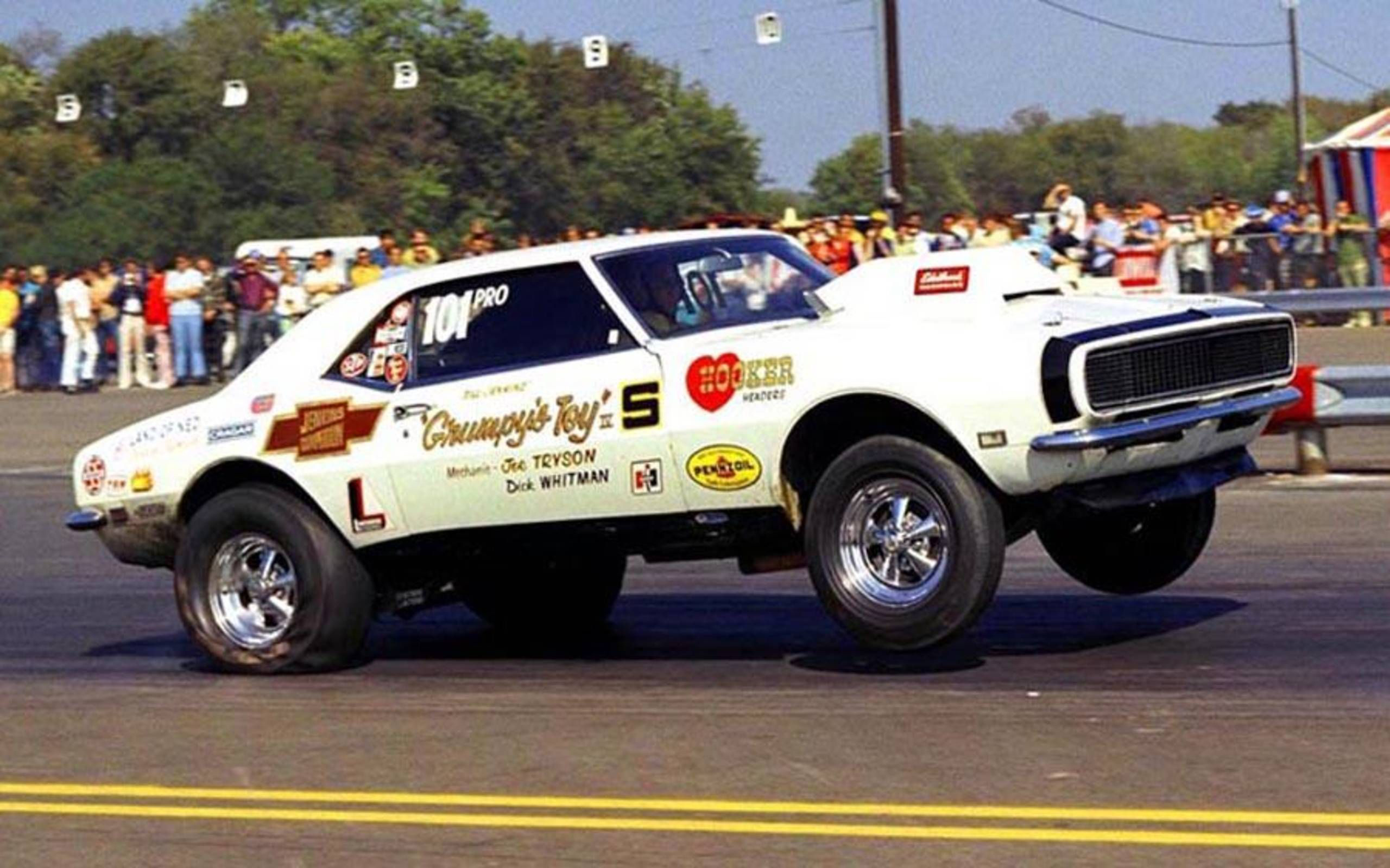 Bill Jenkins' white Grumpy's Toy Camaro launching at the drag strip