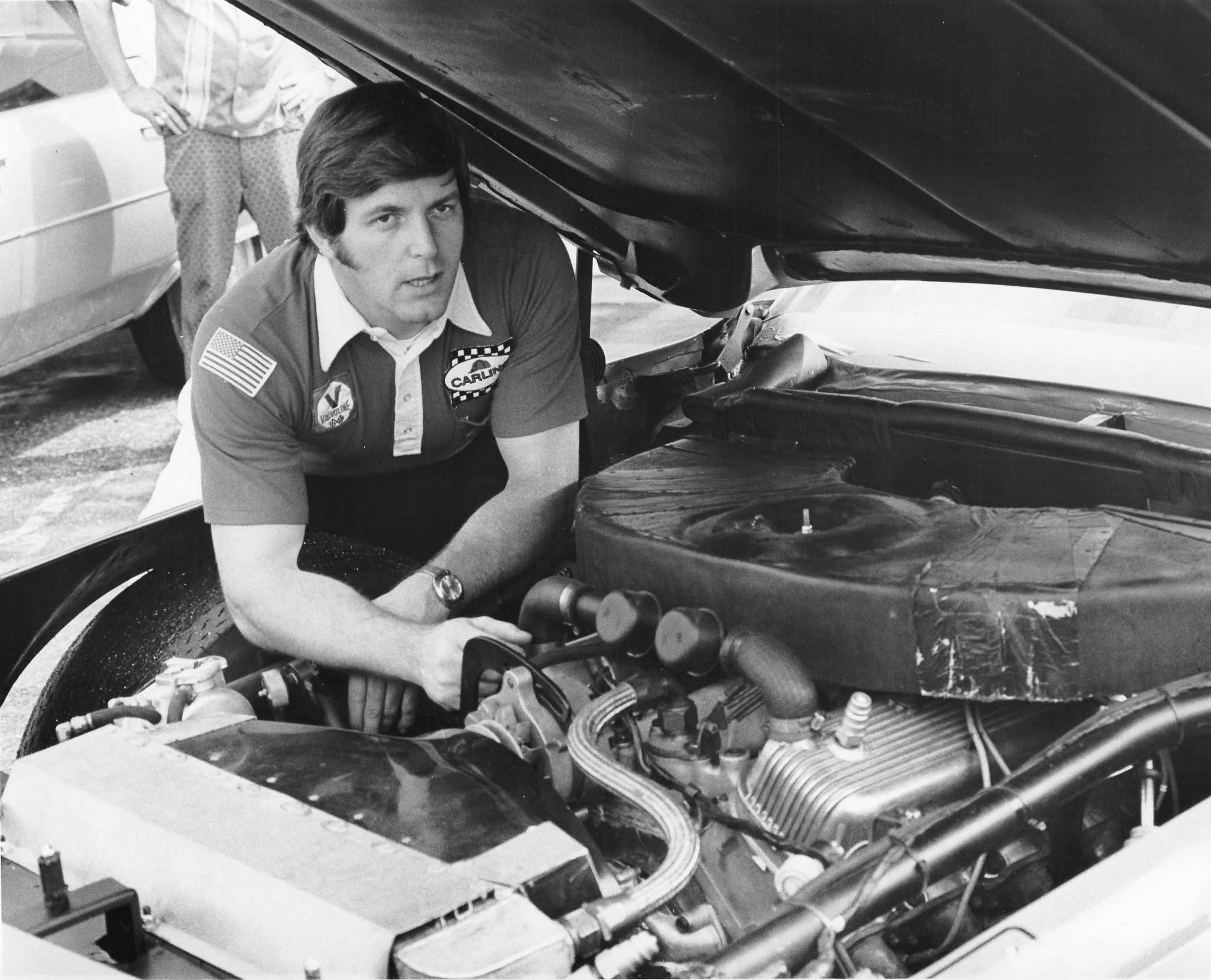 A young Robert Yates working beneath the hood of a stock car
