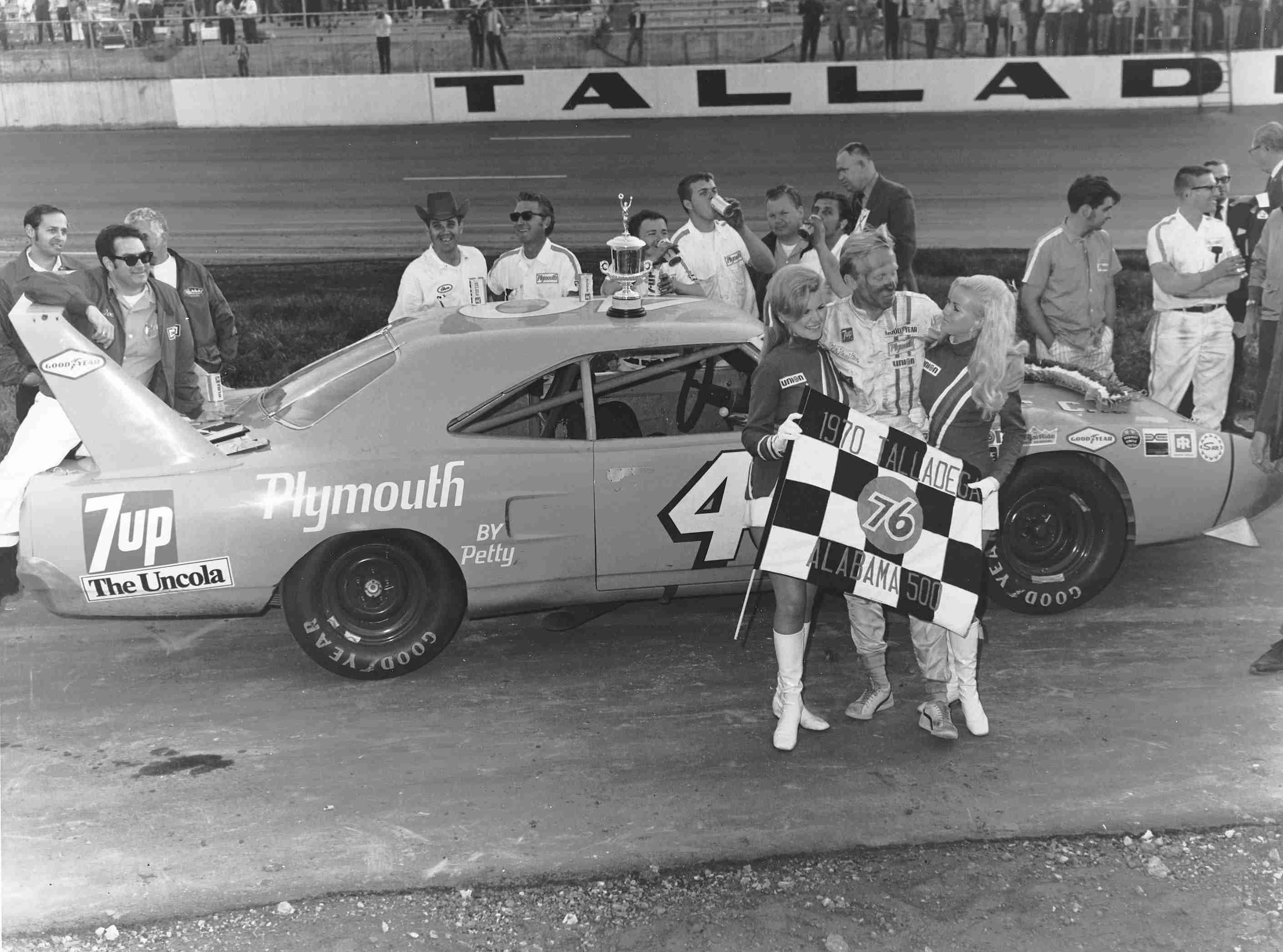 Petty Enterprises crew members celebrating beside Richard Petty's number 43 Plymouth at Talladega