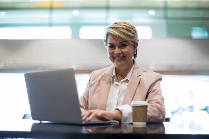 A women creating Engaging Virtual Presentations on her laptop like a boss.
