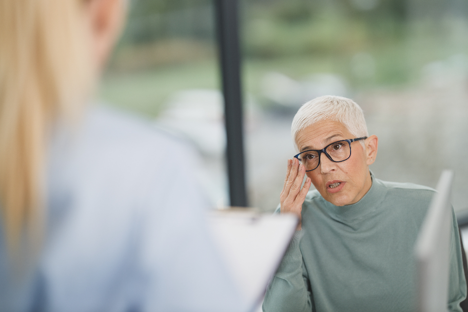 Woman with glasses talking in an office
