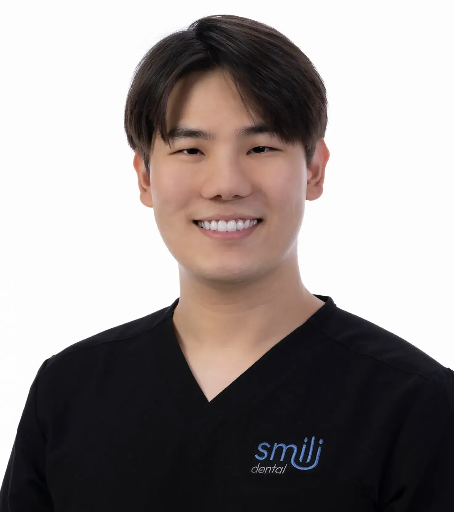 A male in a black shirt is smiling.