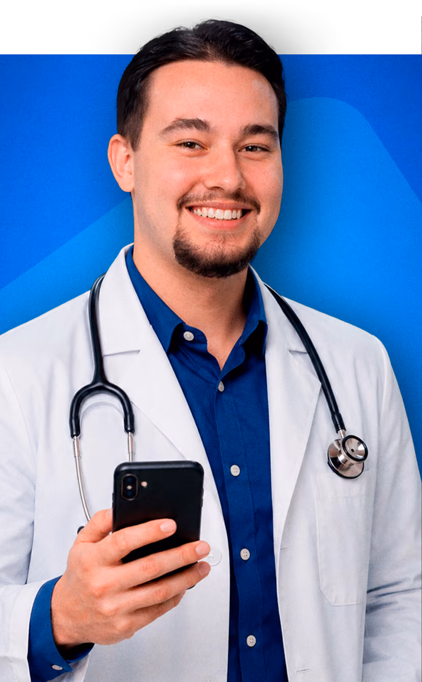 Smiling male doctor wearing white coat and stethoscope holding a smartphone against a blue background.