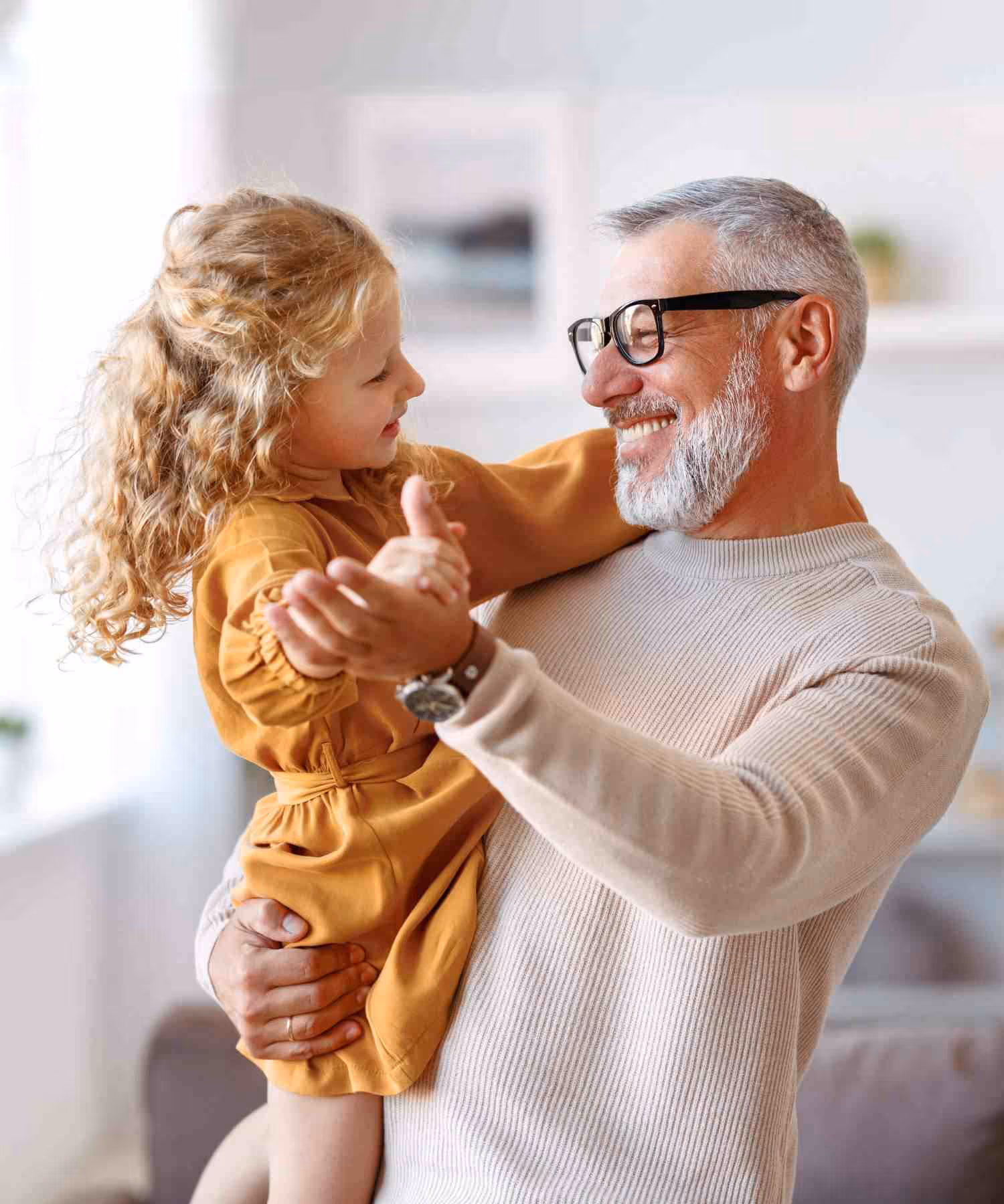 Grandfather dancing with Grandchild, happy and smiling. Plan for retirement with Bayntree Wealth Advisors in Scottsdale, and the greater Phoenix area in Arizona. 