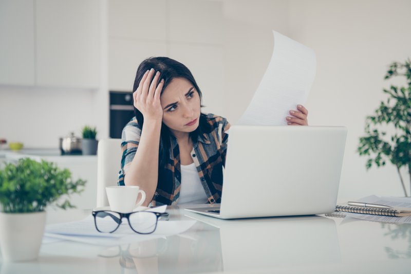 Portrait of beautiful disappointed lady have despair panic stare data look, dont know what do sit table desk large apartment wear checkered shirt plaid