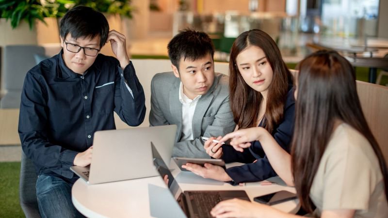 Employees reviewing documentation together after reporting a workplace violation in California