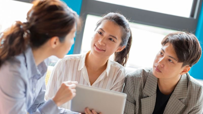 Employees meeting with a California final paycheck attorney to discuss unpaid wages and waiting time penalties