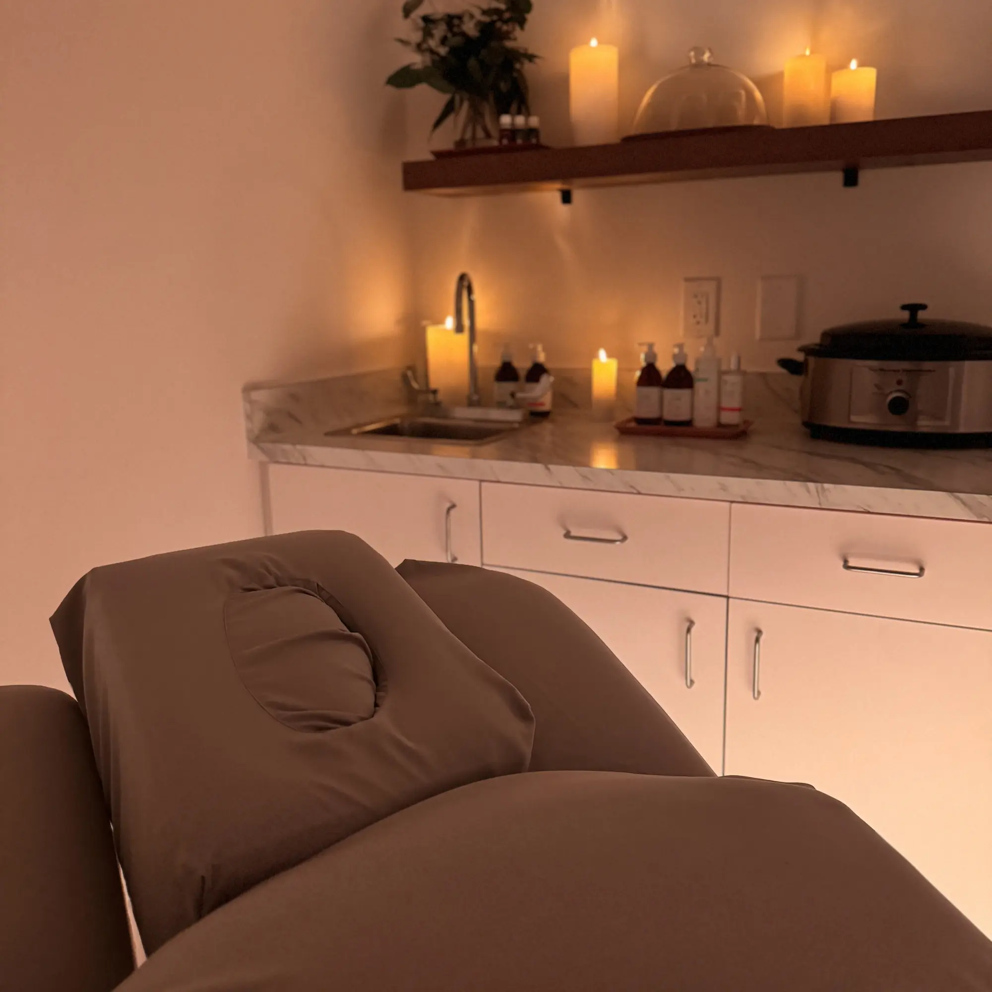 A woman receiving a facial treatment in a serene salon environment, showcasing relaxation and skincare expertise.
