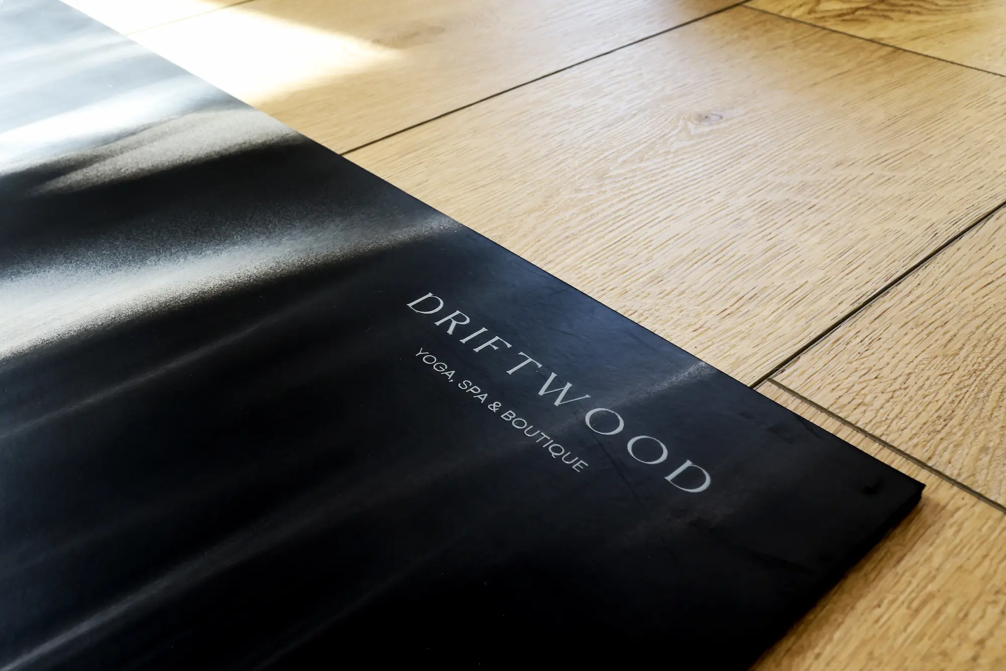 A woman practicing yoga in a serene room with white walls, promoting tranquility and mindfulness.